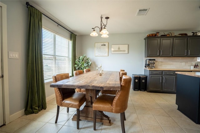 1410 Sherry Dr, Taylor, TX 76574 - dining space featuring light tile patterned flooring and a chandelier