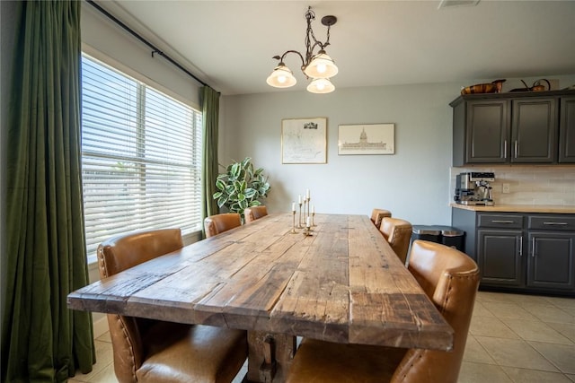 1410 Sherry Dr, Taylor, TX 76574 - dining space featuring light tile patterned floors and a chandelier