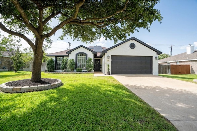 1410 Sherry Dr, Taylor, TX 76574 - ranch-style house with solar panels, a garage, and concrete driveway