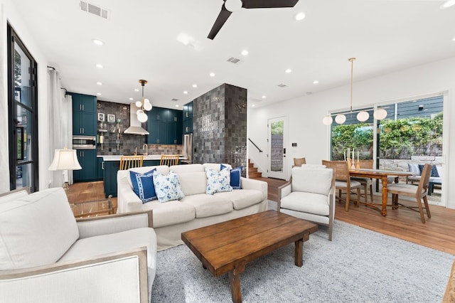 606 Augusta Ave Unit 1, Austin, TX 78703 - living room featuring recessed lighting, ceiling fan, light wood-style floors, and stairs