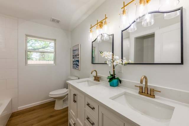106 Heron, Highland Haven, TX 78654 - bathroom featuring double vanity and wood finished floors