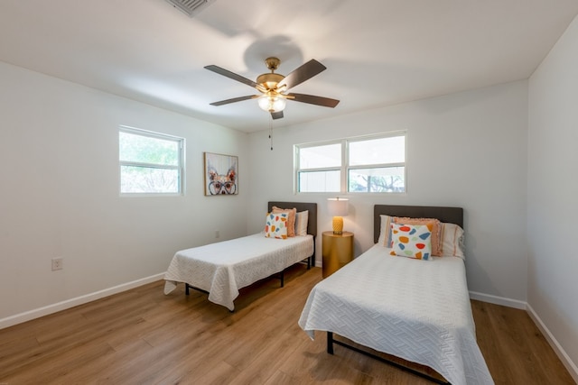 106 Heron, Highland Haven, TX 78654 - bedroom featuring light wood finished floors and a ceiling fan