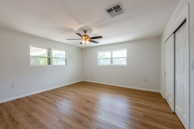 106 Heron, Highland Haven, TX 78654 - unfurnished bedroom with wood finished floors, a ceiling fan, and a closet