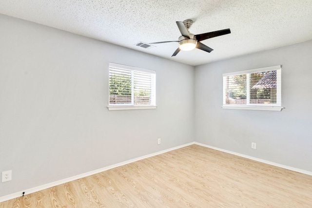 6100 Calmar Cv, Austin, TX 78721 - unfurnished room with a ceiling fan, wood finished floors, and a textured ceiling