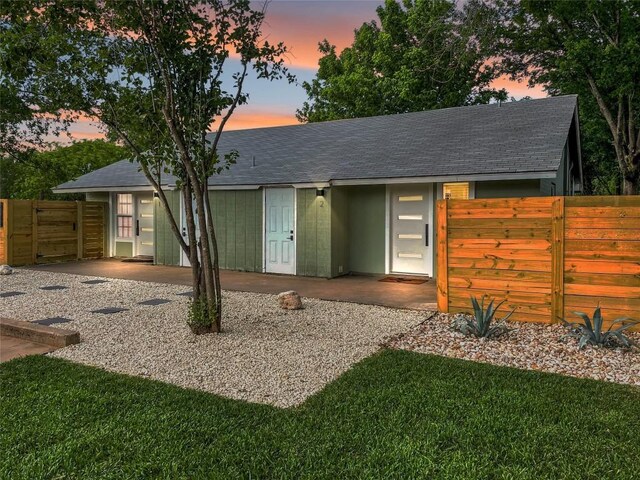 6100 Calmar Cv, Austin, TX 78721 - view of front of property featuring a shingled roof, a gate, and a patio area