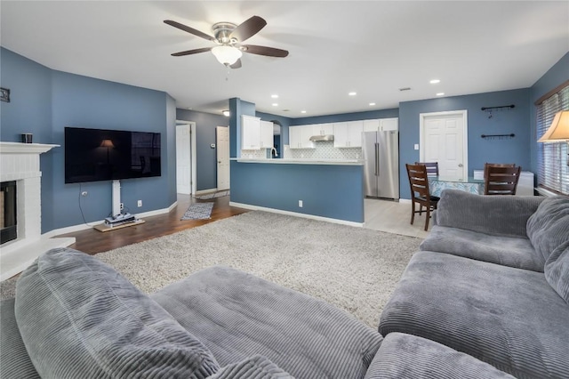 207 Presidio Dr, Leander, TX 78641 - living room with a ceiling fan, light wood finished floors, a fireplace, and recessed lighting