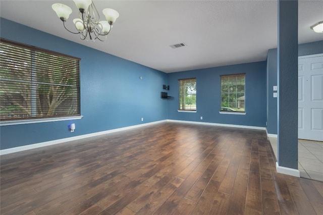 207 Presidio Dr, Leander, TX 78641 - spare room featuring wood finished floors and a chandelier