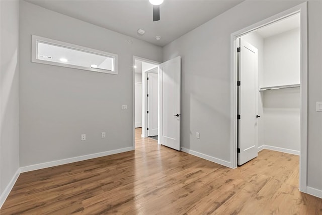 4510 Terry-O Ln Unit 415, Austin, TX 78745 - unfurnished bedroom featuring light wood-style flooring, a ceiling fan, a walk in closet, and a closet