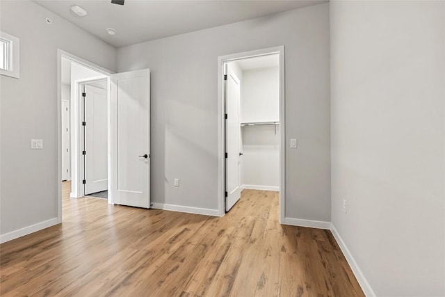 4510 Terry-O Ln Unit 415, Austin, TX 78745 - unfurnished bedroom with light wood-type flooring, a spacious closet, and a closet