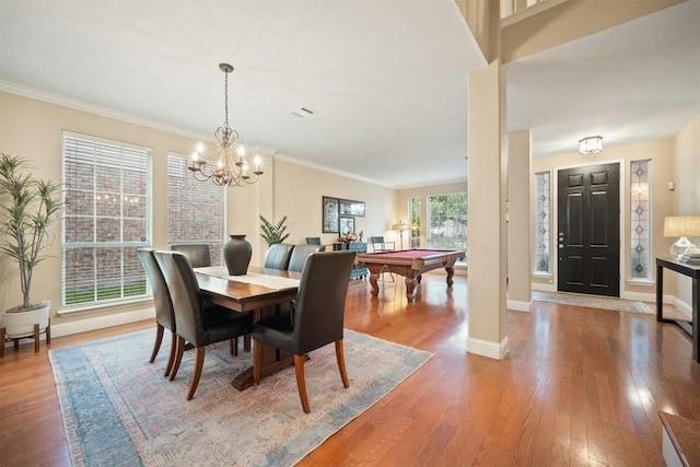 1215 Boerne Dr, Cedar Park, TX 78613 - dining space with pool table, wood finished floors, a chandelier, and ornamental molding