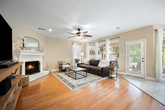 1215 Boerne Dr, Cedar Park, TX 78613 - living room with light wood-type flooring, a fireplace, a ceiling fan, and recessed lighting