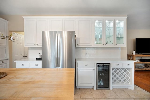 1215 Boerne Dr, Cedar Park, TX 78613 - kitchen with beverage cooler, freestanding refrigerator, glass insert cabinets, white cabinets, and light tile patterned floors