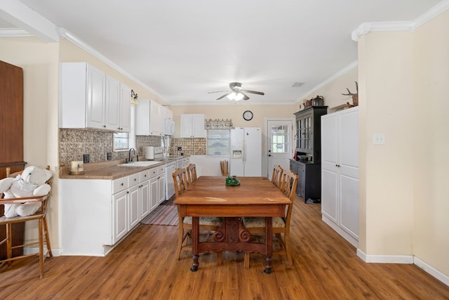 429 W 4th St, Flatonia, TX 78941 - dining area featuring plenty of natural light, ceiling fan, light wood-type flooring, and ornamental molding