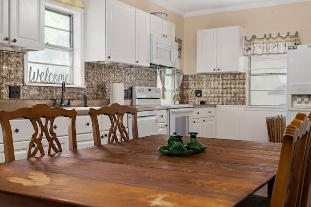429 W 4th St, Flatonia, TX 78941 - kitchen featuring white appliances, white cabinets, decorative backsplash, wood counters, and ornamental molding