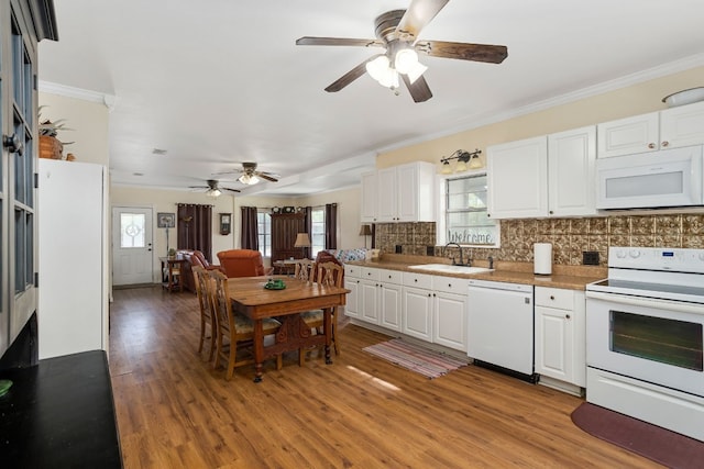 429 W 4th St, Flatonia, TX 78941 - kitchen featuring white appliances, a ceiling fan, decorative backsplash, light wood-style flooring, and crown molding