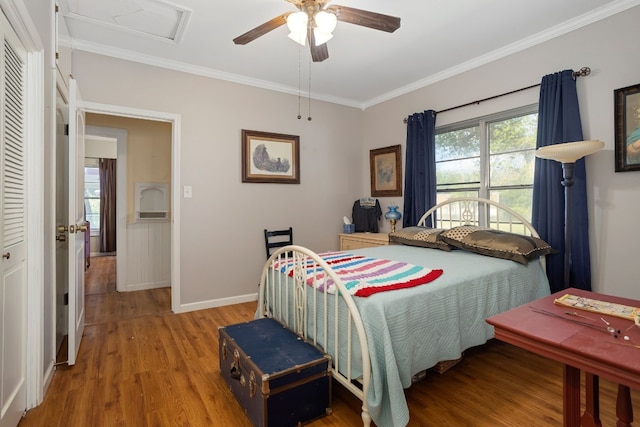 429 W 4th St, Flatonia, TX 78941 - bedroom with ornamental molding, wood finished floors, multiple windows, attic access, and ceiling fan