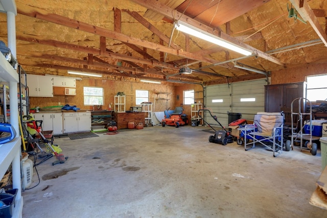 429 W 4th St, Flatonia, TX 78941 - garage featuring a garage door opener and a workshop area