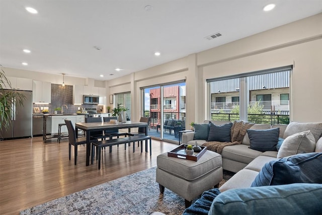 4361 S Congress Ave Unit 435, Austin, TX 78745 - living area featuring wood finished floors and recessed lighting