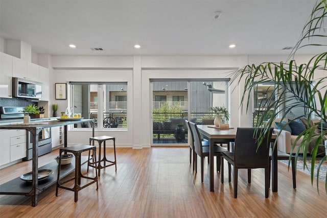 4361 S Congress Ave Unit 435, Austin, TX 78745 - dining space featuring light wood-style flooring and recessed lighting