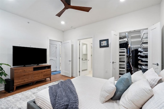 4361 S Congress Ave Unit 435, Austin, TX 78745 - bedroom featuring recessed lighting, wood finished floors, connected bathroom, a walk in closet, and ceiling fan