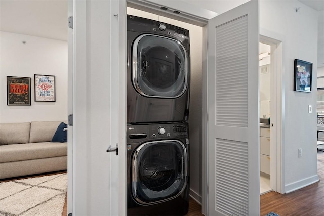 4361 S Congress Ave Unit 435, Austin, TX 78745 - laundry room featuring estacked washer and dryer and dark wood finished floors