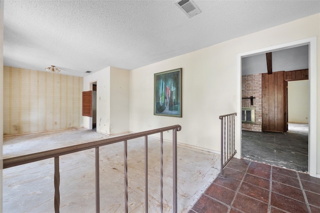 11702 Shoshone Dr, Austin, TX 78759 - spare room with a textured ceiling and a fireplace