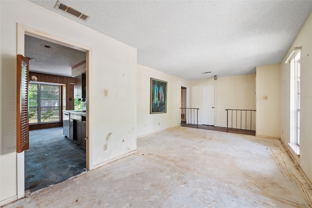11702 Shoshone Dr, Austin, TX 78759 - empty room featuring a textured ceiling and baseboards