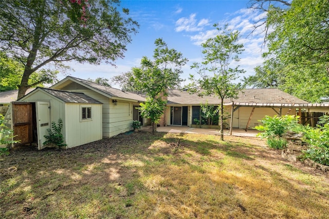11702 Shoshone Dr, Austin, TX 78759 - back of property with a patio area, a storage unit, and a lawn