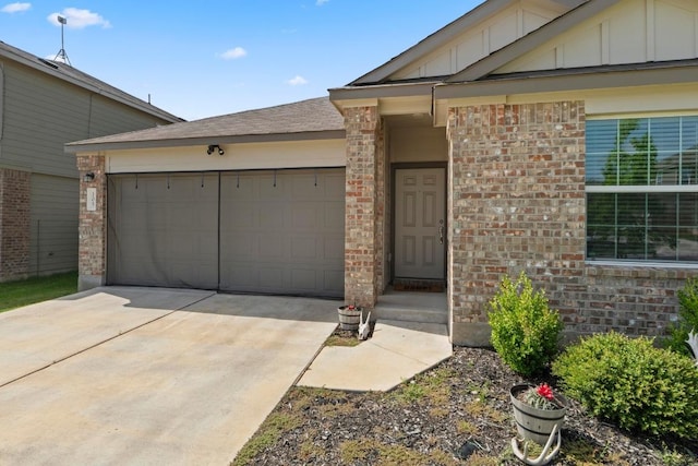 105 Perfect World Loop, Jarrell, TX 76537 - view of front of home featuring board and batten siding, a garage, driveway, and brick siding
