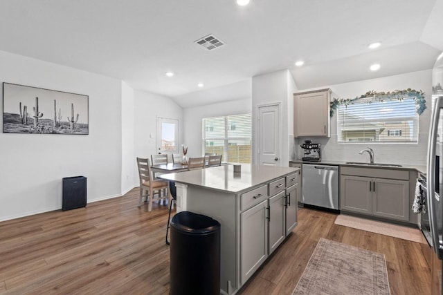 105 Perfect World Loop, Jarrell, TX 76537 - kitchen featuring gray cabinetry, dishwasher, wood finished floors, decorative backsplash, and recessed lighting