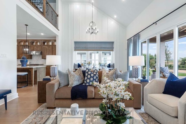1401 Snowdrop Dr, Georgetown, TX 78628 - living area featuring high vaulted ceiling, a chandelier, light wood-style flooring, and recessed lighting