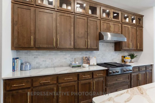 1401 Snowdrop Dr, Georgetown, TX 78628 - kitchen with ventilation hood, backsplash, stainless steel gas stovetop, and light stone countertops