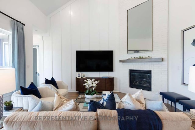 1401 Snowdrop Dr, Georgetown, TX 78628 - living room featuring wood finished floors, a brick fireplace, and high vaulted ceiling