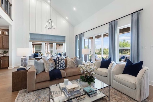 1401 Snowdrop Dr, Georgetown, TX 78628 - living room featuring high vaulted ceiling, a chandelier, light wood-type flooring, and recessed lighting