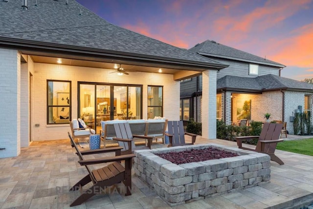 1401 Snowdrop Dr, Georgetown, TX 78628 - back of house at dusk with a patio area, brick siding, and a ceiling fan
