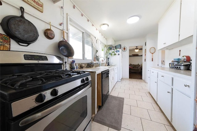 936 Cheatham St, San Marcos, TX 78666 - kitchen featuring stainless steel gas stove, black dishwasher, white cabinets, and a ceiling fan