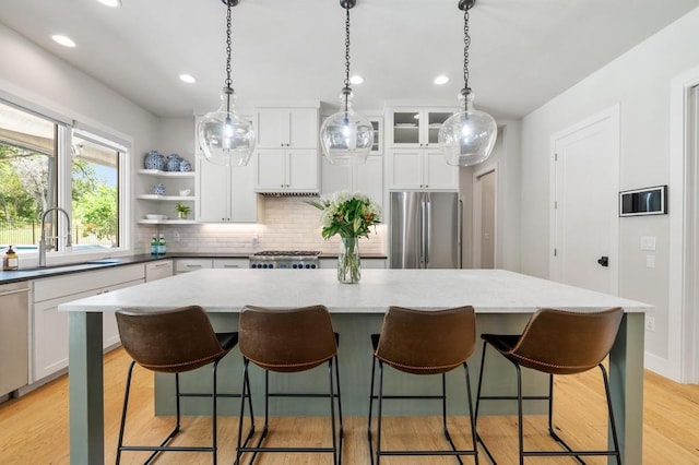 2600 Arion Cir, Austin, TX 78730 - kitchen with stainless steel fridge, a center island, tasteful backsplash, recessed lighting, and white cabinetry