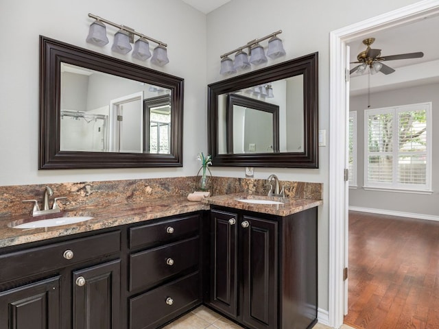 17029 Ennis Trl, Austin, TX 78717 - bathroom featuring double vanity, a ceiling fan, and wood finished floors