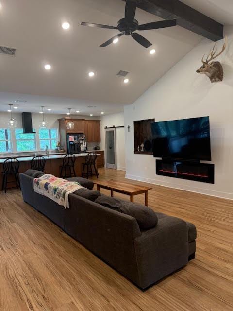 305 Goertz Dr, Red Rock, TX 78662 - living area with a barn door, light wood-style flooring, a ceiling fan, and recessed lighting