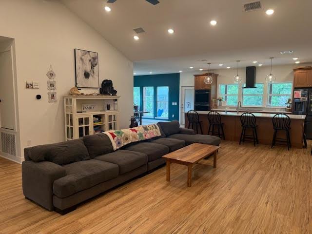 305 Goertz Dr, Red Rock, TX 78662 - living area featuring light wood-style floors, recessed lighting, ceiling fan, and vaulted ceiling