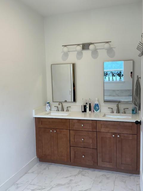 305 Goertz Dr, Red Rock, TX 78662 - bathroom featuring marble finish floors and double vanity