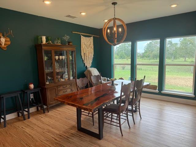 305 Goertz Dr, Red Rock, TX 78662 - dining space featuring a chandelier, wood finished floors, and recessed lighting