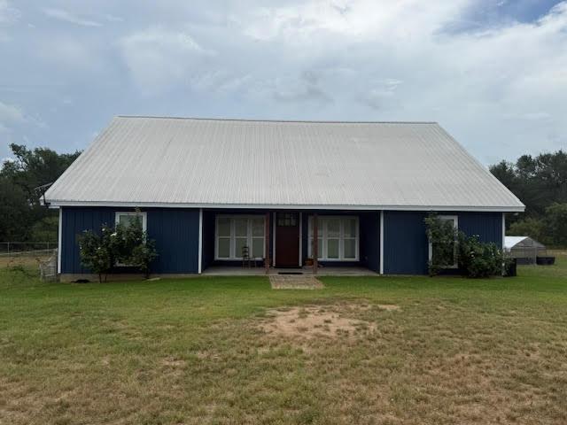 305 Goertz Dr, Red Rock, TX 78662 - single story home featuring a front yard and a metal roof