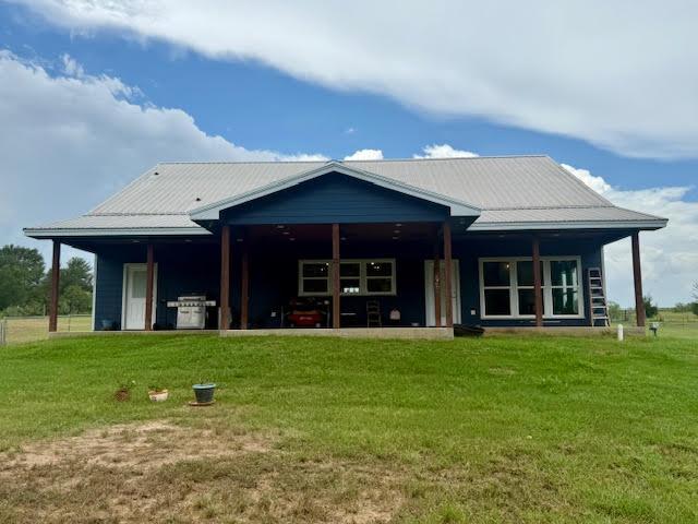 305 Goertz Dr, Red Rock, TX 78662 - back of house featuring a yard and a metal roof