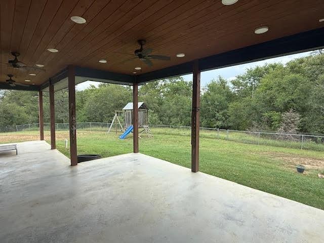 305 Goertz Dr, Red Rock, TX 78662 - fenced backyard featuring a ceiling fan, a playground, and a patio