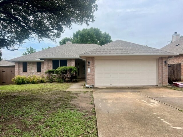 612 Thrush Dr, Leander, TX 78641 - single story home with brick siding, a garage, concrete driveway, a shingled roof, and a chimney