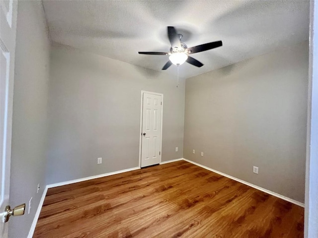612 Thrush Dr, Leander, TX 78641 - empty room featuring a ceiling fan, wood finished floors, and a textured ceiling