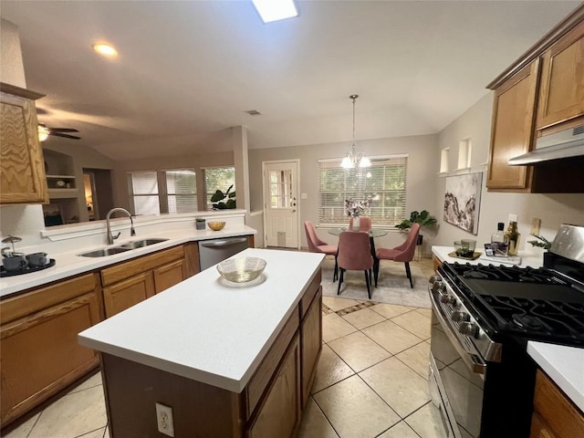 612 Thrush Dr, Leander, TX 78641 - kitchen featuring stainless steel appliances, light countertops, lofted ceiling, brown cabinetry, and a center island