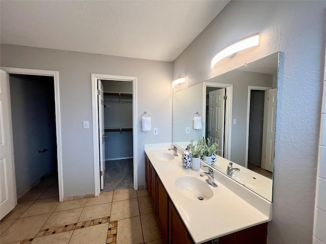 612 Thrush Dr, Leander, TX 78641 - full bathroom featuring double vanity, tile patterned floors, and a spacious closet