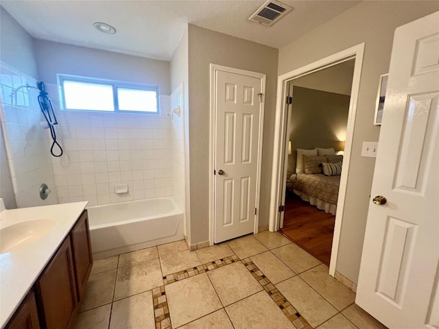 612 Thrush Dr, Leander, TX 78641 - ensuite bathroom with tile patterned flooring, tub / shower combination, and vanity